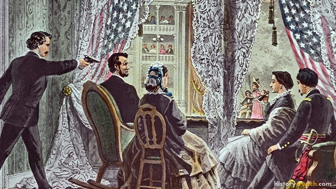 John Wilkes Booth leaning forward to shoot President Abraham Lincoln as he watches Our American Cousin at Ford's Theatre in Washington, D.C., on April 14th, 1865.
