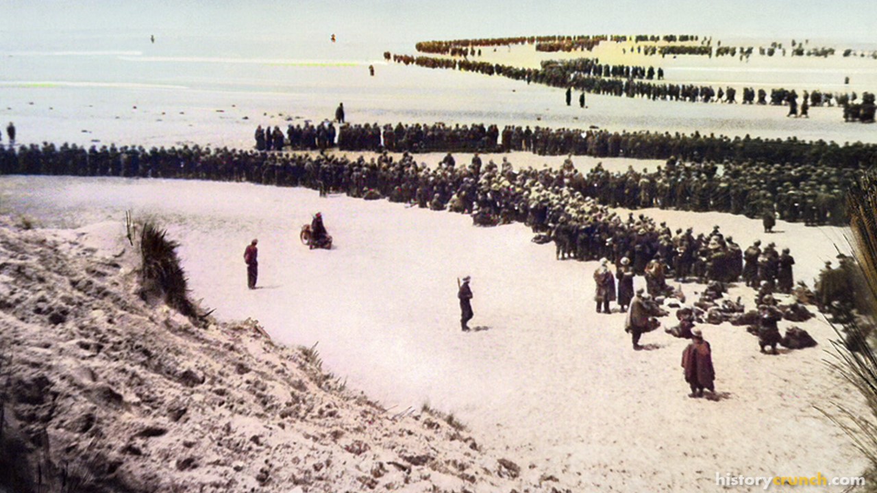 British troops line up on the beach at Dunkirk in 1940 to await evacuation. (Colorized by historycrunch.com)